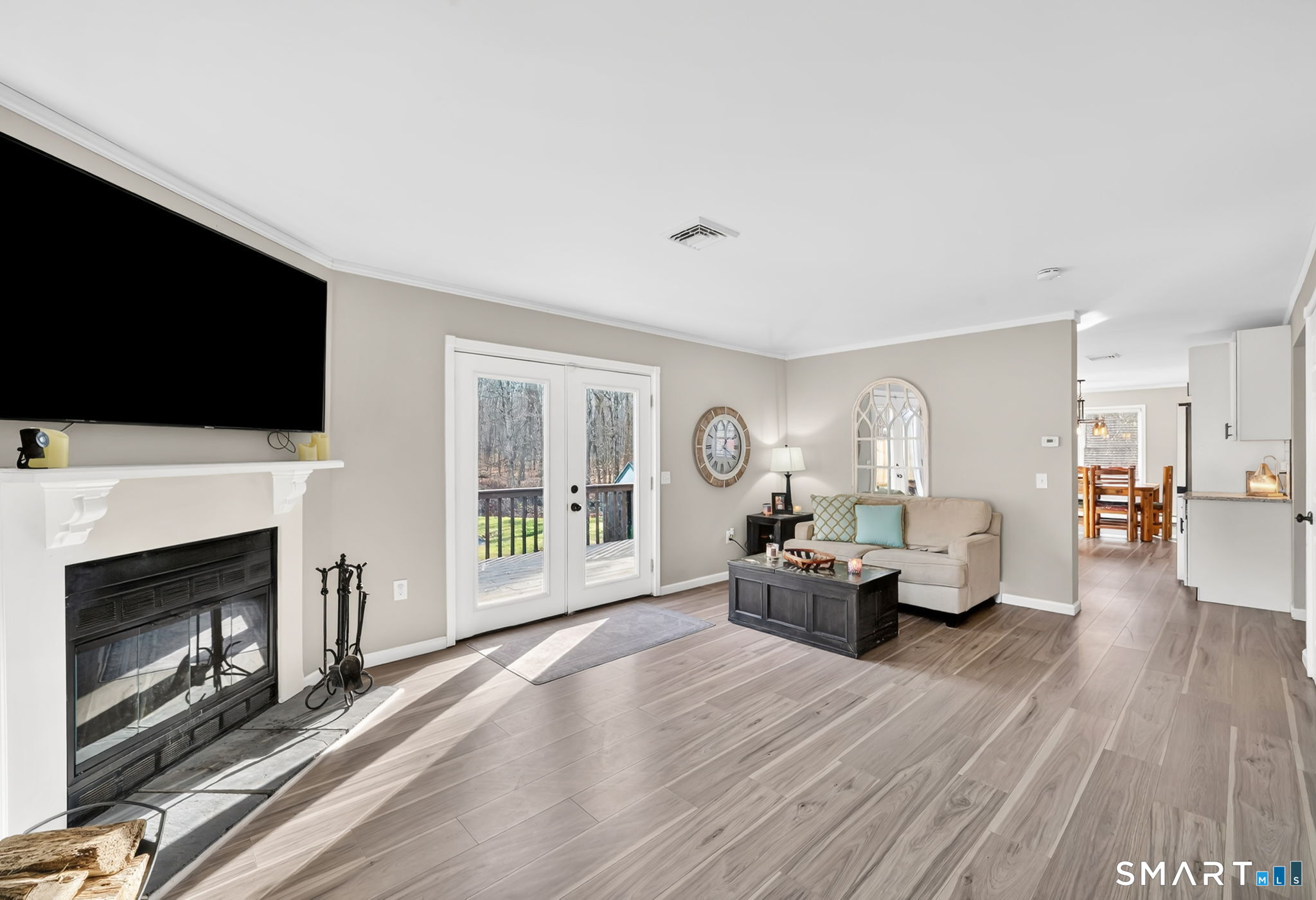 97 Bass Road Windham, CT 06280 - Photo 17 of 40 a living room with furniture a fireplace and a flat screen tv