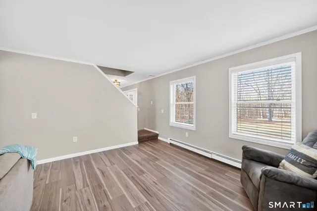 wooden floor in an empty room with a window