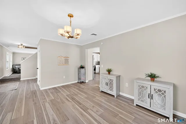 a view of a room with wooden floor