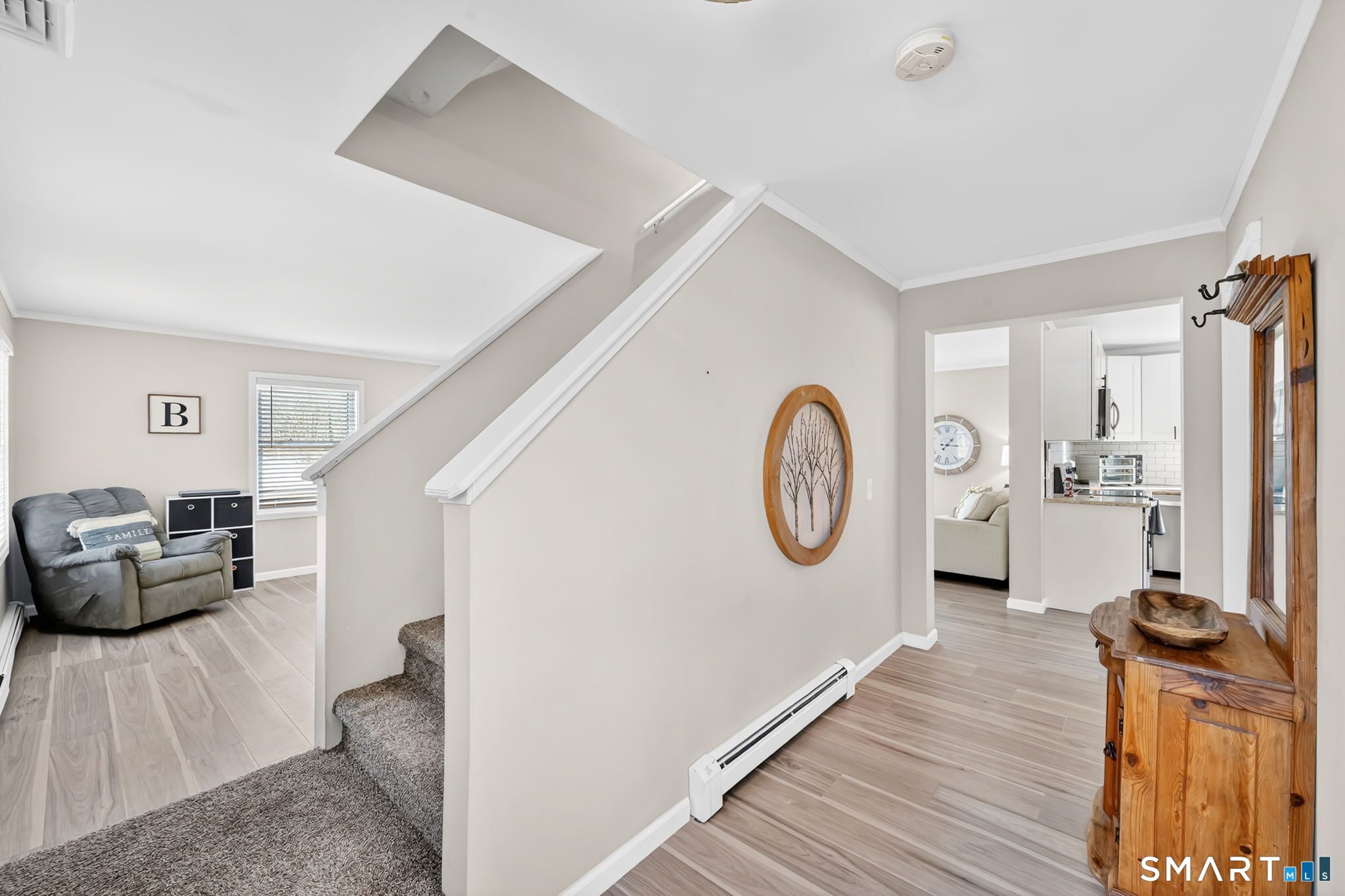 97 Bass Road Windham, CT 06280 - Photo 28 of 40 a living room with furniture a clock and wooden floor