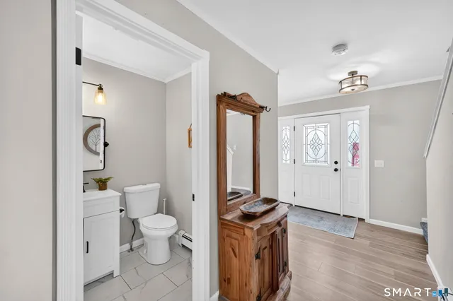 a bathroom with a toilet sink and a mirror
