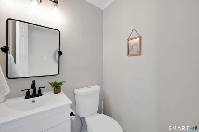 a white toilet sitting next to a bathroom sink
