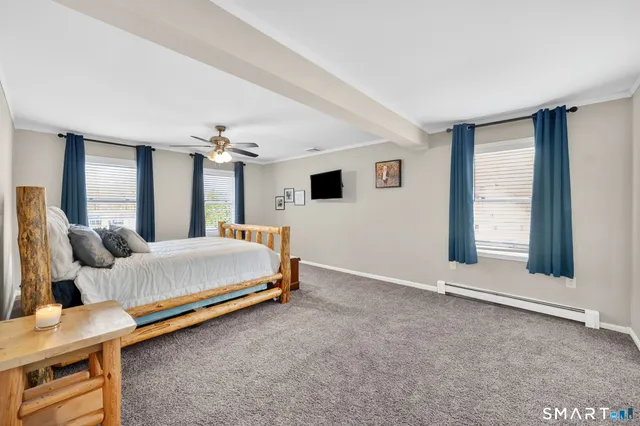 a spacious bedroom with a bed and window