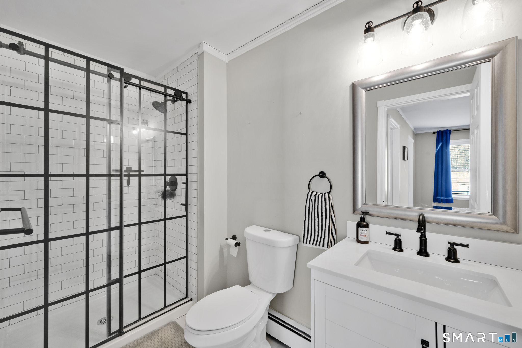 97 Bass Road Windham, CT 06280 - Photo 33 of 40 a bathroom with a sink a toilet and shower