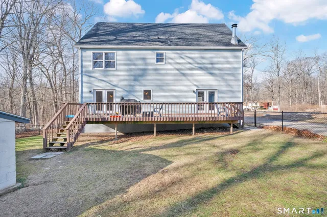 a view of a house with a yard and sitting area