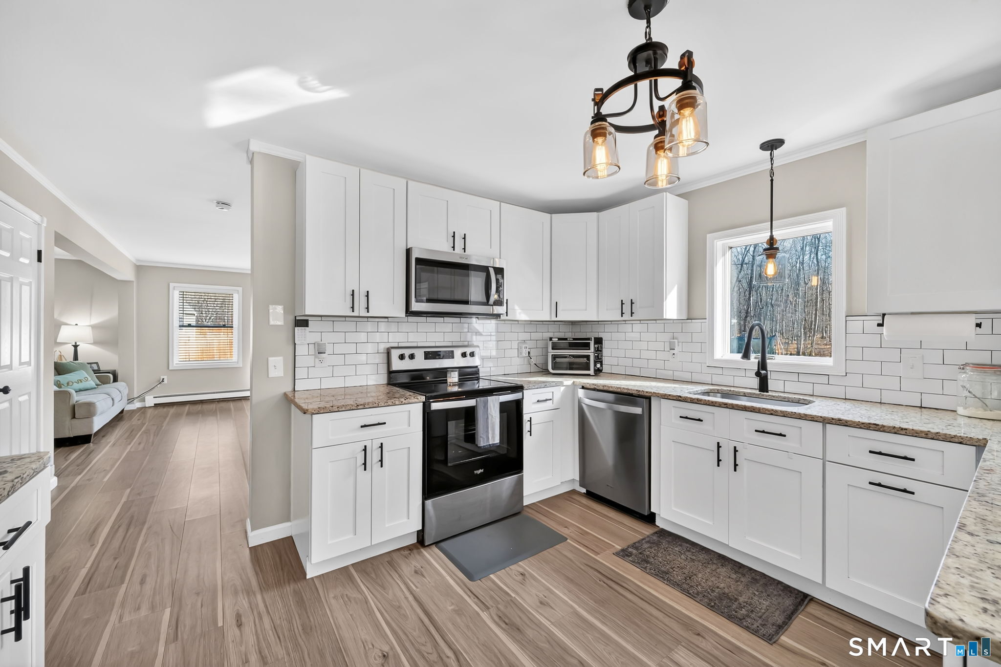 97 Bass Road Windham, CT 06280 - Photo 7 of 40 a kitchen with cabinets a sink and stainless steel appliances