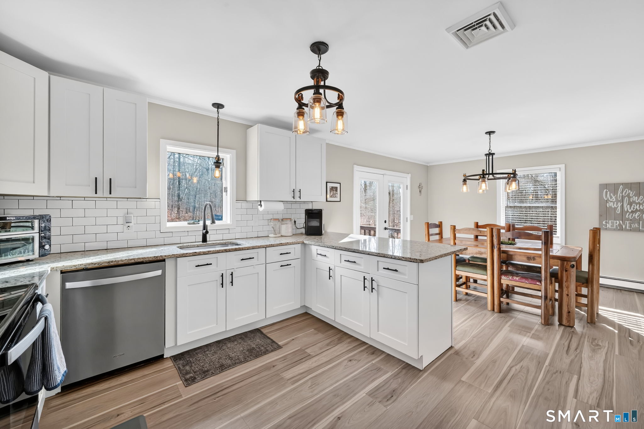 97 Bass Road Windham, CT 06280 - Photo 8 of 40 a kitchen with granite countertop a sink cabinets and wooden floor