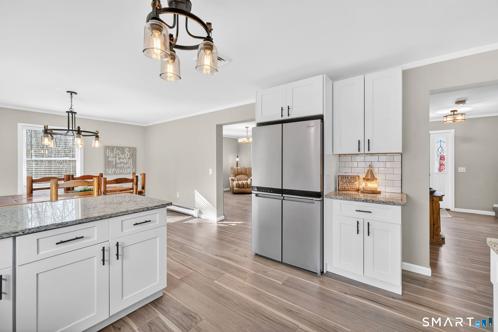 97 Bass Road Windham, CT 06280 - Photo 9 of 40 a kitchen with kitchen island white cabinets and stainless steel appliances