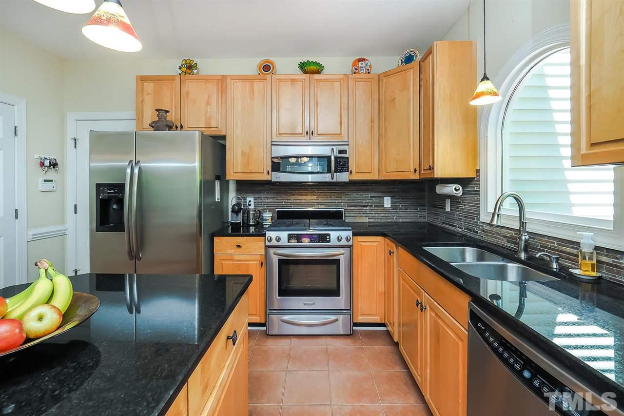 3309 Byers Drive Raleigh, NC 27607 - Photo 5 of 25 Solid surface counters, island and gas stove. Refrigerator conveys with the home.