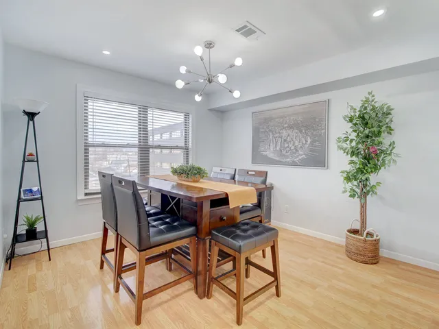 a view of a dining room with furniture and a potted plant