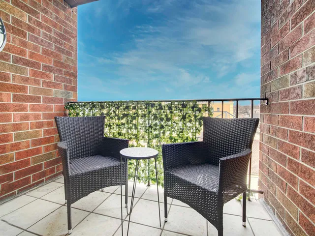 a view of a chairs and table in the back