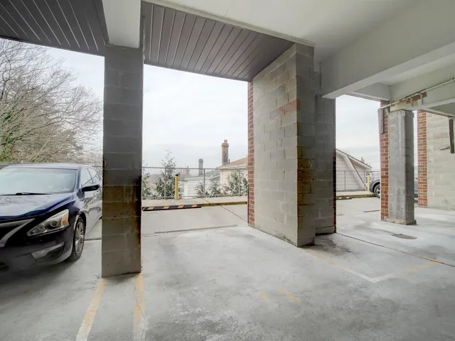 a view of a hallway with furniture and floor to ceiling window
