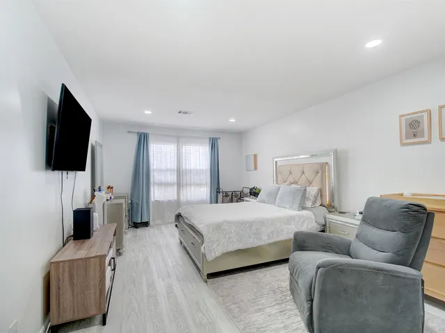 a bedroom with a bed and a flat screen television