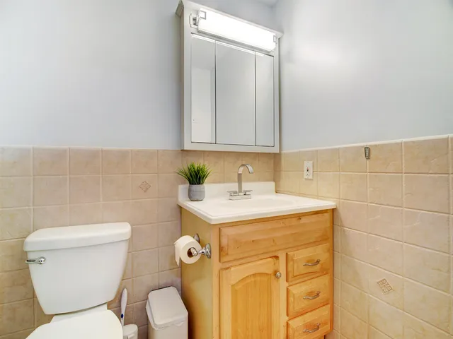 a bathroom with a sink a toilet and a mirror