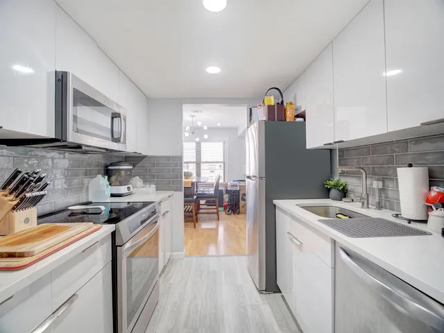 a kitchen that has a sink and a stove in it