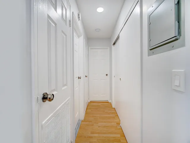 a view of a hallway with wooden floor