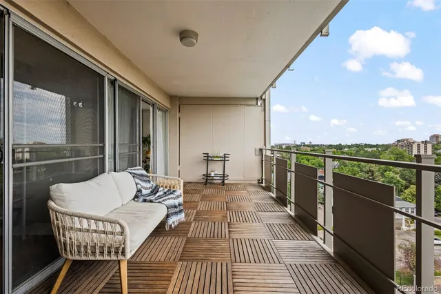 a balcony with furniture and a rug