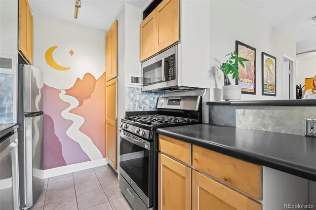 a kitchen with stainless steel appliances granite countertop a stove and a microwave