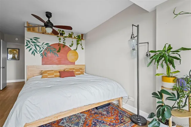 a bedroom with a bed and potted plant