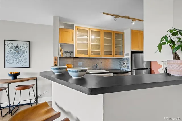 a kitchen with a sink and a stove top oven