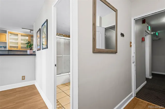 a view of a hallway with wooden floor and staircase