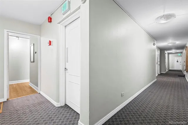a view of hallway with wooden floor