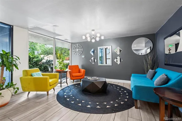 a living room with furniture and a chandelier