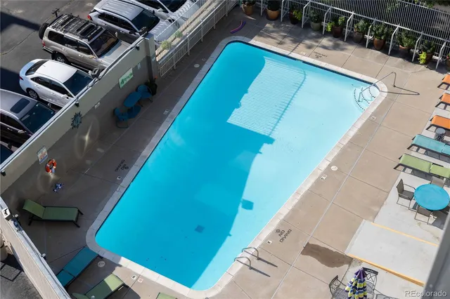 a room with pool table and windows