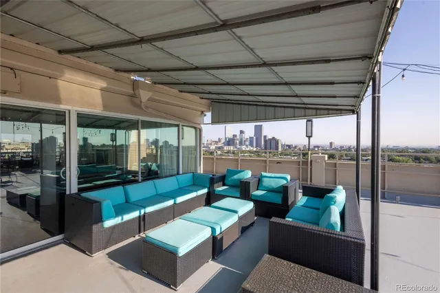 a view of a patio with a table and chairs