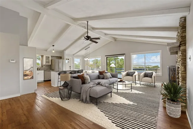 a living room with fireplace furniture and a large window