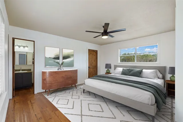 a bedroom with a large bed and a chandelier