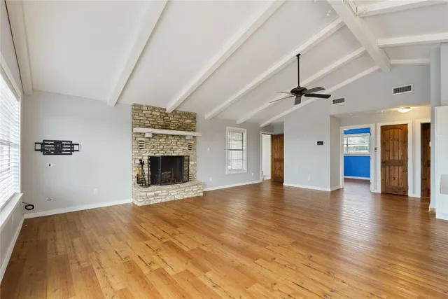 wooden floor in an empty room with a fireplace