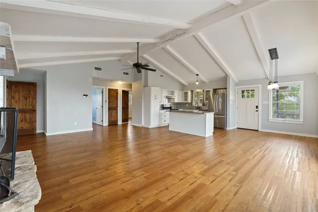 a view of a kitchen with furniture and wooden floor