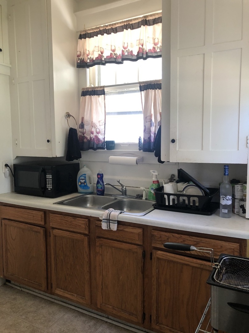 300 North Maple Street Normal, IL 61761 - Photo 9 of 18 a kitchen with stainless steel appliances granite countertop a sink a stove a counter space and cabinets