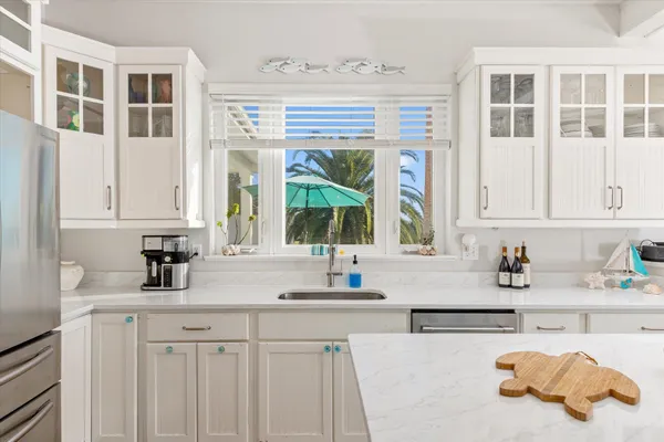a large white tub sitting in a bathroom next to a window