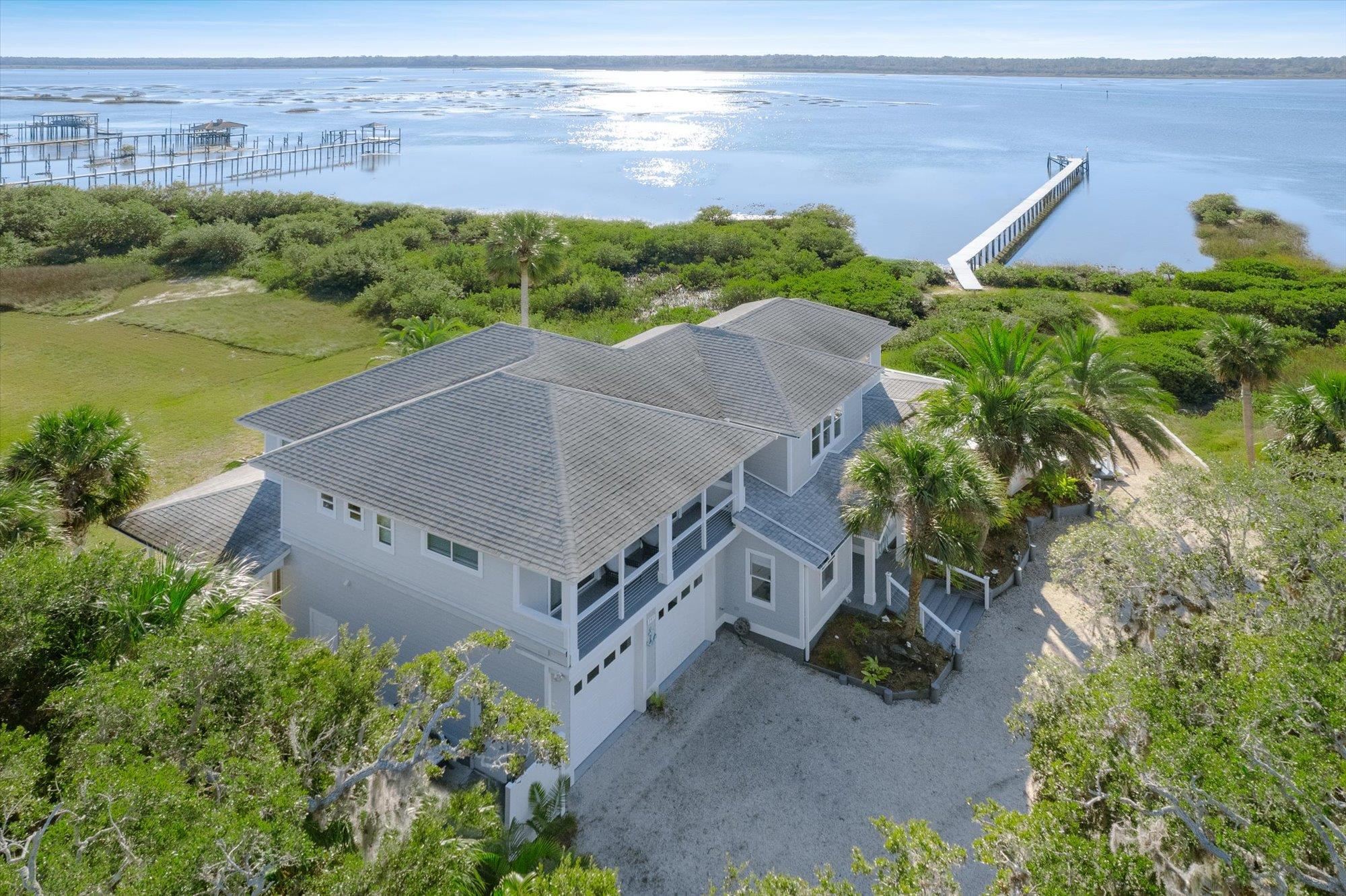 345 Micklers Road St. Augustine, FL 32080 - Photo 75 of 100 an aerial view of a house with a garden and lake view