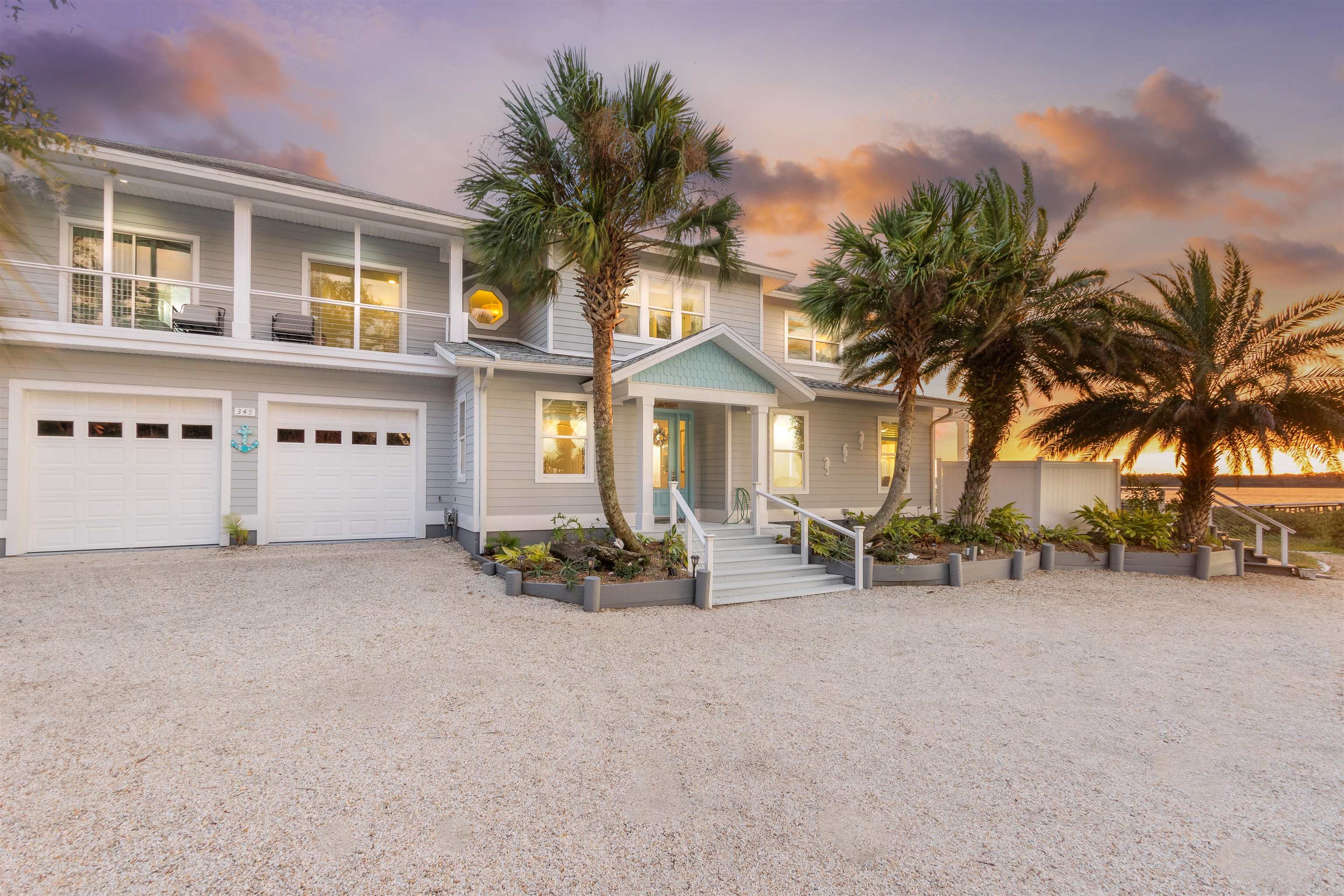 345 Micklers Road St. Augustine, FL 32080 - Photo 8 of 100 front view of a house with sitting area and palm trees
