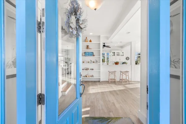 a large open kitchen with a large window and stainless steel appliances
