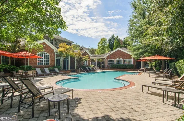 a view of a house with swimming pool and sitting area