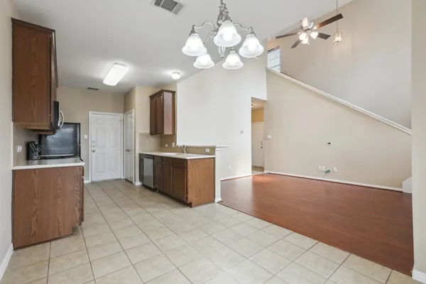 a large kitchen with kitchen island granite countertop a sink a stove a counter space and cabinets