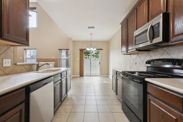 a kitchen with stainless steel appliances granite countertop a sink and stove top oven