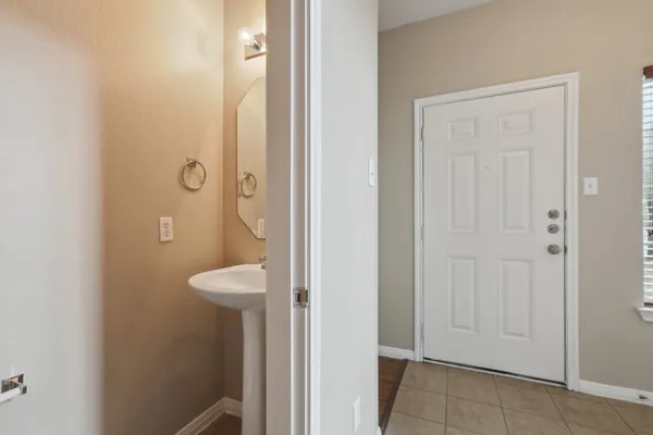 a bathroom with a granite countertop sink