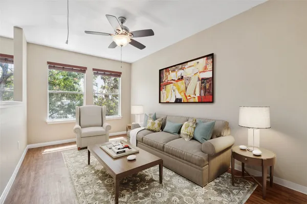 a living room with furniture a lamp on table and a window