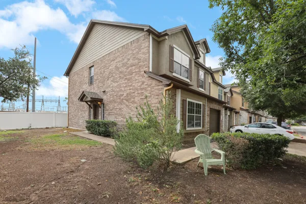 a view of a house with backyard and sitting area