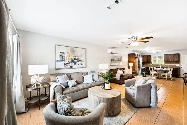 a living room with furniture and kitchen view