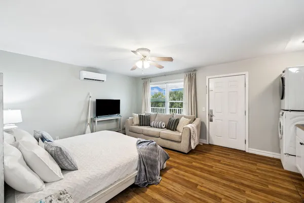 a kitchen with stainless steel appliances white cabinets a stove a sink and a potted plant