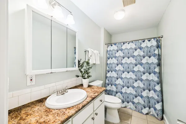 a bathroom with a sink a mirror and a toilet