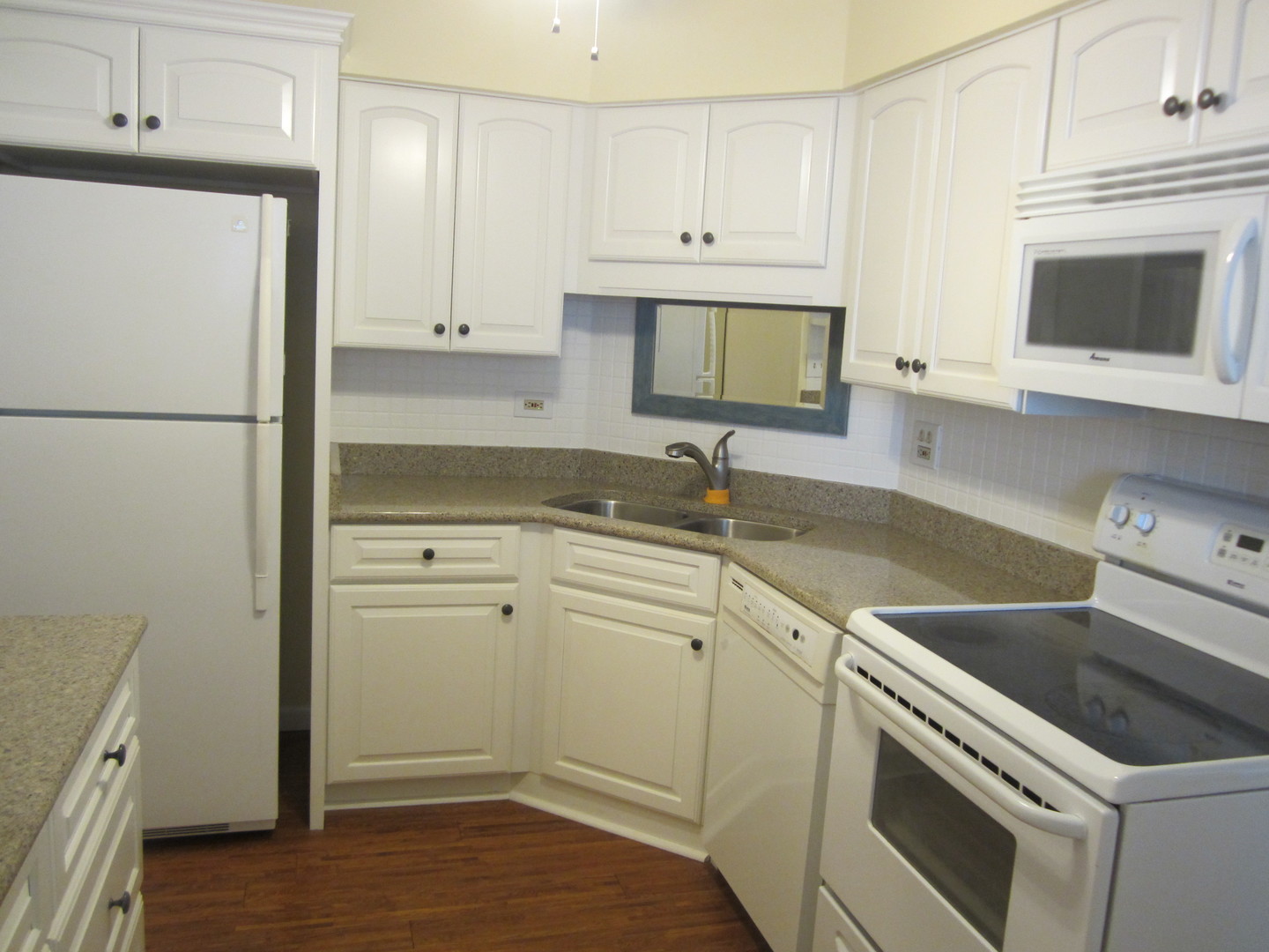 15 Bar Harbour Road, Unit 4G Schaumburg, IL 60193 - Photo 7 of 21 a kitchen with a sink stove and refrigerator