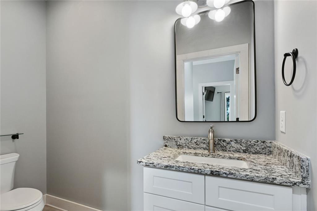 2040 Ridge Road Cumming, GA 30041 - Photo 33 of 52 a bathroom with a toilet sink vanity and mirror