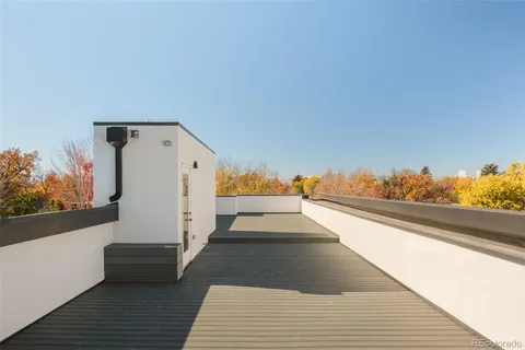 a view of a balcony with wooden floor and fence